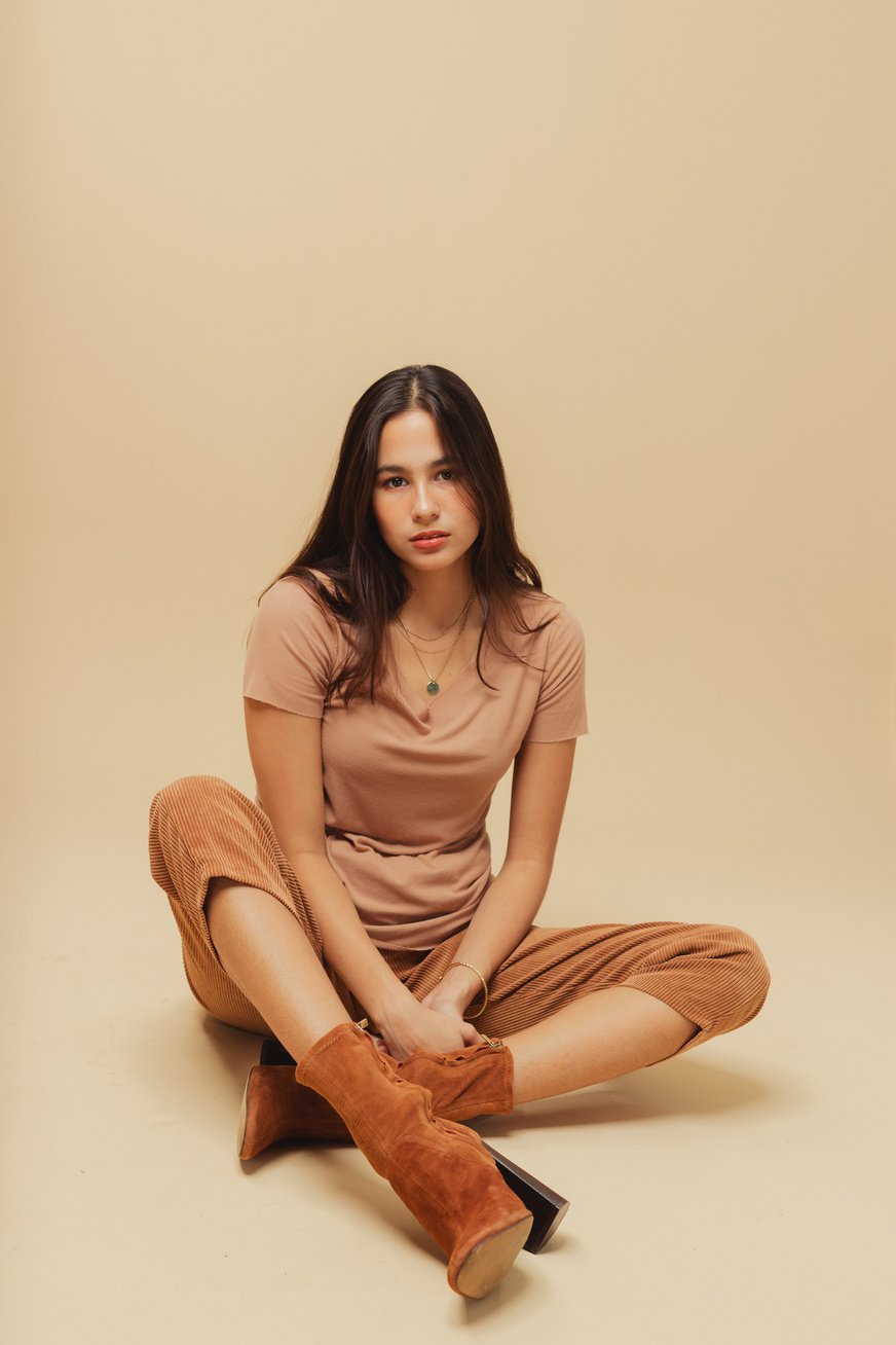 Woman in Brown Monochrome Outfit on Beige Background